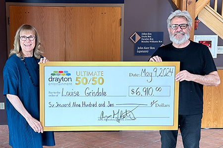 Louise Grisdale and Alex Mustakas with a big cheque at St. Jacobs Country Playhouse<