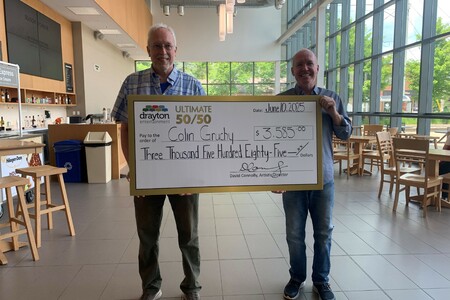Colin Grunchy (left) is pictured holding a large presentation cheque for $3,585 alongside Drayton Entertainment Artistic Director David Connolly (right). The cheque, dated June 10, 2025, celebrates Colin as the winner of the Ultimate 50/50 draw. The