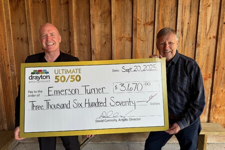 David Connolly presents a giant cheque to Emerson Turner, the winner of Drayton Entertainment’s Ultimate 50/50 Draw. The cheque is made out for $3,670.