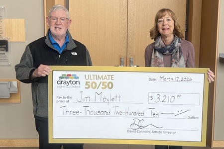 Ellen Berwick presents a giant cheque to Jim Moylett, the winner of Drayton Entertainment’s Ultimate 50/50 Draw. The cheque is made out for $3,210.