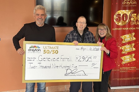 Alex Mustakas presents a giant cheque to Genevieve Farrell, the winner of Drayton Entertainment’s Ultimate 50/50 Draw. The cheque is made out for $2,905