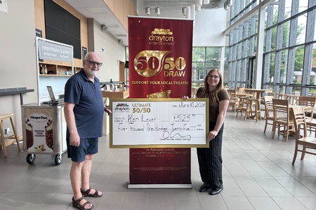 Elizabeth Dwyer presents a giant cheque to Ken Lever, the winner of Drayton Entertainment’s Ultimate 50/50 Draw. The cheque is made out for $5,125.<