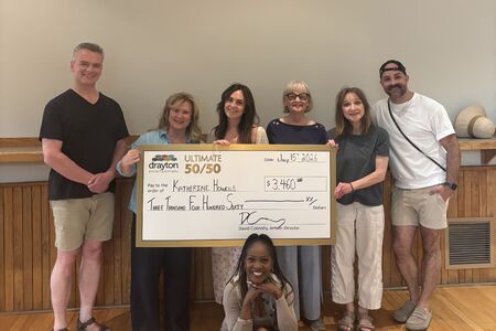 Actors Karen Birthwright, Dave Comeau, Donna Fletcher, Mary Pitt, Glynis Ranney, and Curtis Sullivan present a cheque for $3,460 to Katherine Howells at the Drayton Festival Theatre.