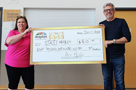 Stratford's Stacey Heinbuch met with Drayton Entertainment's Artistic Director Alex Mustakas to collect her prize after she won June's 50/50.