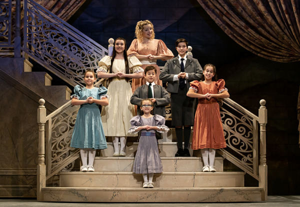 Performers standing on stairs and singing