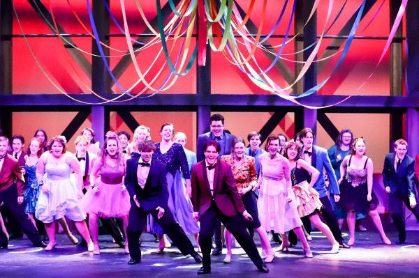 Production photo of Footloose showing the whole company on stage dancing together.