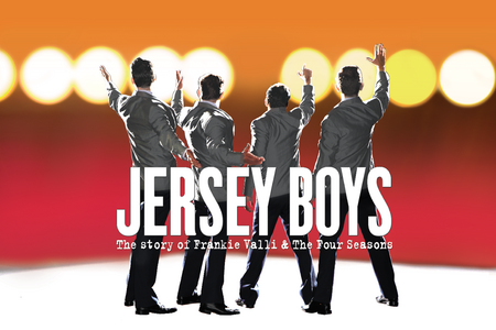 Drayton's logo for JERSEY BOYS. The 4 members of the band stand facing away. on the other side of them , faded stage lights can be seen in a sea of yellow and red.