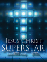 The promotional image for Jesus Christ Superstar features the title in bold, white letters against a sparkling, bokeh background. The backdrop transitions from brightly illuminating a cross outline in the center to shadow and smoke in the perimeter