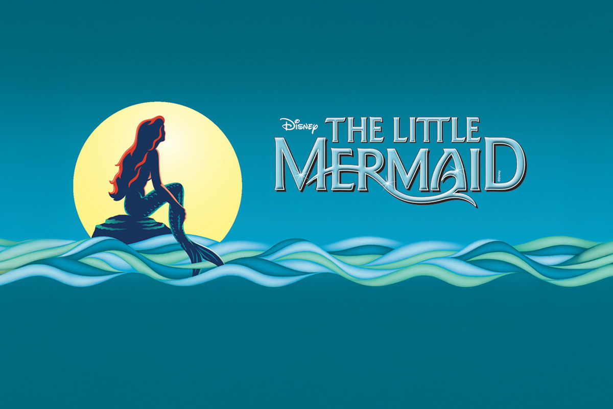 Disney's Little Mermaid appears in bold silver letters against a dark blue starry background, illuminated by a soft spotlight that creates a theatrical, Broadway-inspired atmosphere.