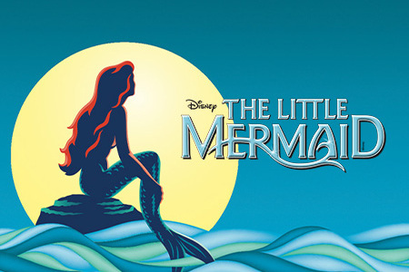 Disney's Little Mermaid appears in bold silver letters against a dark blue starry background, illuminated by a soft spotlight that creates a theatrical, Broadway-inspired atmosphere.