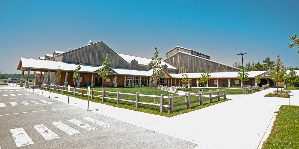A view of the front courtyard outside of the Huron Country Playhouse on a bright, summer day.