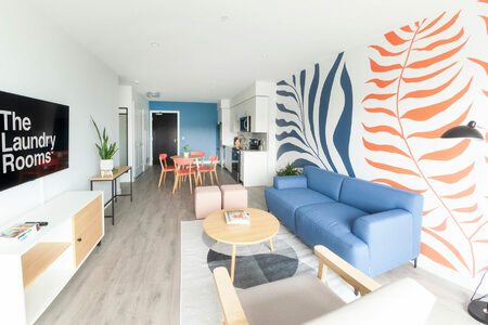 Interior shot of the kitchen, dining, and living area of a unit in The Laundry Rooms in Cambridge.